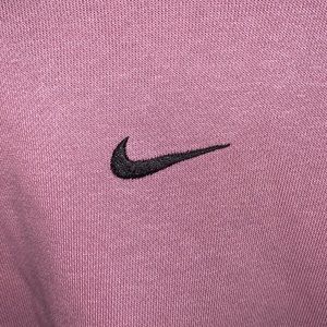 large purple nike crewneck with ribbon on sleeves
